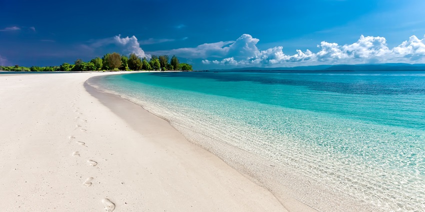 Visitors enjoy sand and water at Bagan Lalang Beach, a popular beach near Kuala Lumpur.
