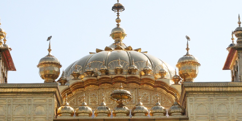 Exterior view of Bagore Sahib Gurudwara near Bhilwara, surrounded by trees and a peaceful rural landscape.