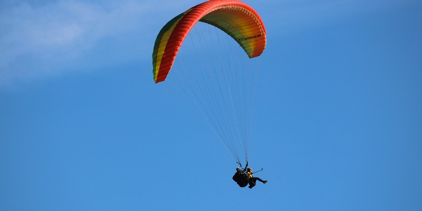 Paragliding near Udaipur above Badi Lake offers serene views and lush vibrant hills.