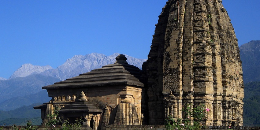 Baijnath Temple, with its intricate stone carvings and towering spire, against the backdrop of the Himalayas