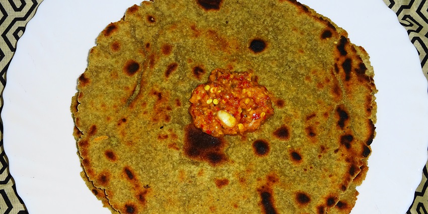 An image of Bajre Ki Roti which is a millet flatbread with garlic chutney or jaggery.