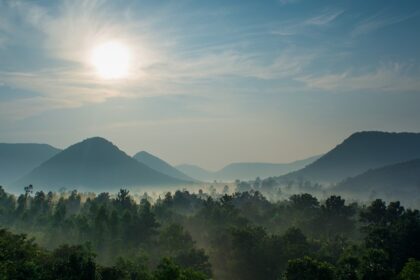 Picturesque view overlooking the sun hues reflecting on the misty mountains of Balimela wildlife sanctuary