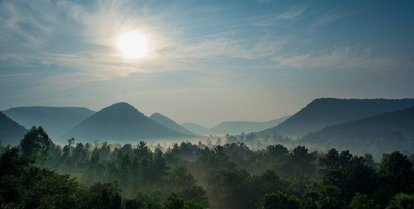 Picturesque view overlooking the sun hues reflecting on the misty mountains of Balimela wildlife sanctuary