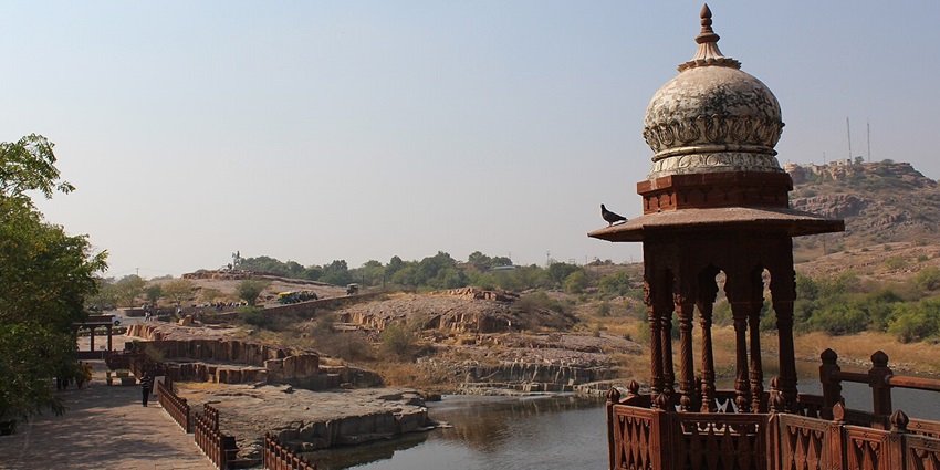 An image of the historic Balsamand Lake with the heritage palace on its banks.