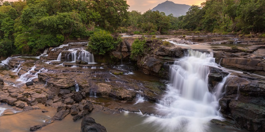 Water cascading down a cliff at the scenic Bananbudo Waterfalls in Canacona