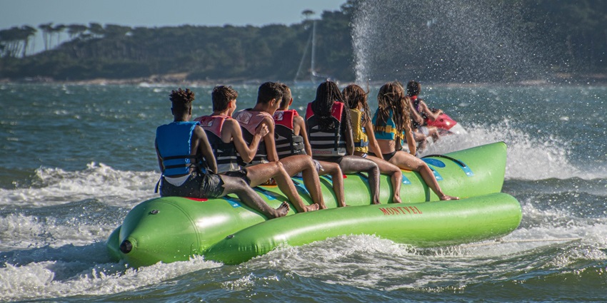 A picture of a group of people enjoying a banana boat ride at the Candolim beach