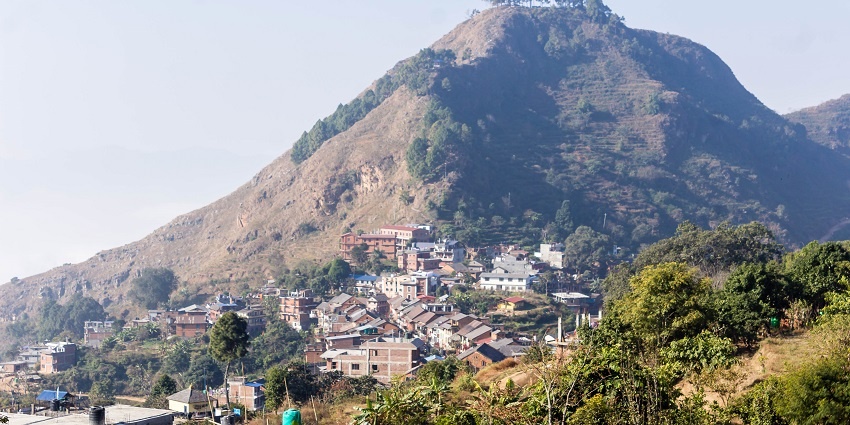 A picture of a town with a hill in the background, in Nepal which is one of the best places to visit for couples