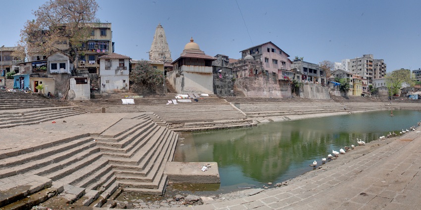 Historic Banganga Tank surrounded by temples, offering serene reflection