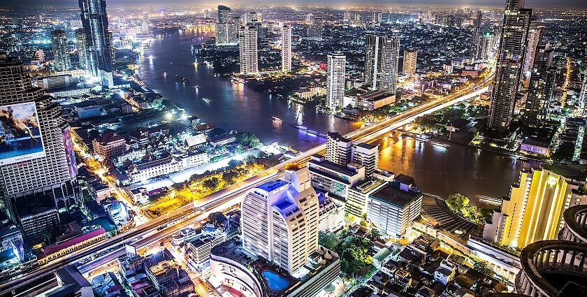 An aerial view of the Bangkok skyline at night which is a famous spot for rooftop parties