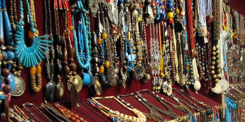 Bustling Jaipur market with vibrant stalls, colourful textiles, and people shopping