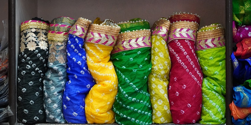Bapu Bazaar features Rajasthani textiles, Bandhani fabrics, quilts, juttis, leather goods.