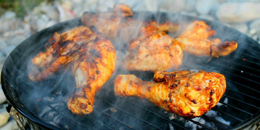A glimpse of marinated chicken being barbequed on a grill at the Barbeque Nation.