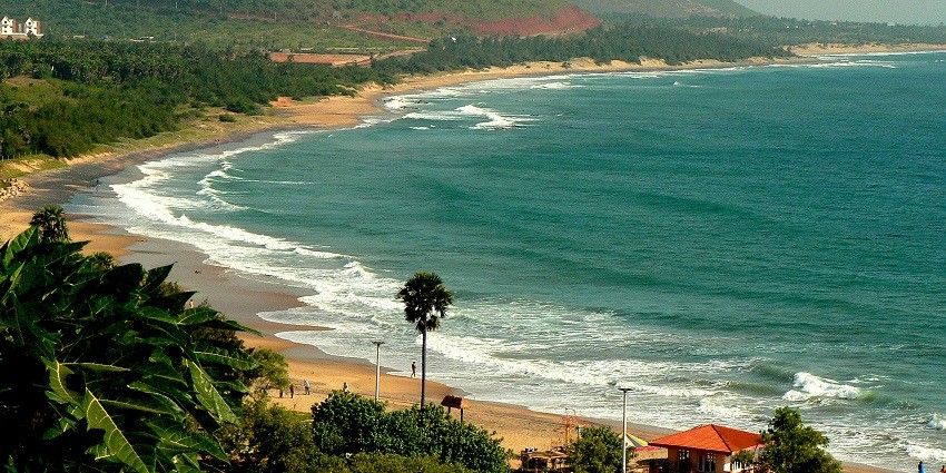 Picturesque view of the turquoise water waves crashing on the golden shores of the beach