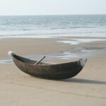 A breathtaking view of one of the Beaches in Kumta with a wooden boat on the shore.