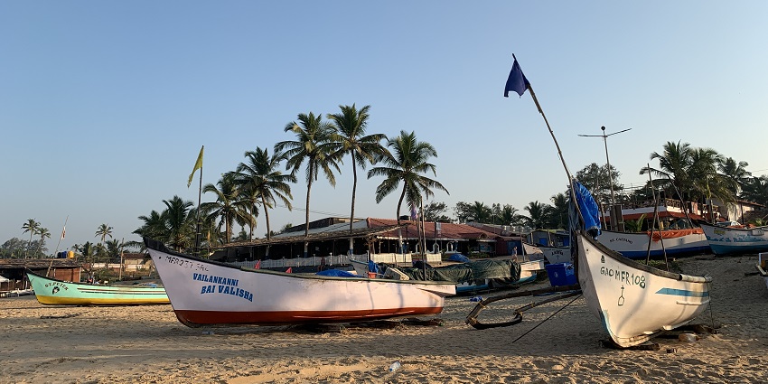 Image of two hand rowed boats standing on the beach near the Varca in Goa