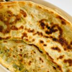 An image of crispy Amritsari Kulcha with chole served at a popular eatery in Ludhiana.