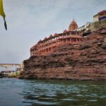 A glimpse of a famous temple in the region of Madhya Pradesh surrounded by azure waters.