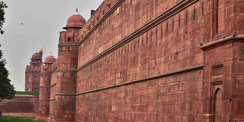 A sideways picture of the Red Fort in Delhi showing its huge red wall