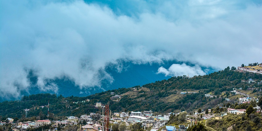 A stunning aerial view of a city in Arunachal Pradesh with houses and lush greenery.