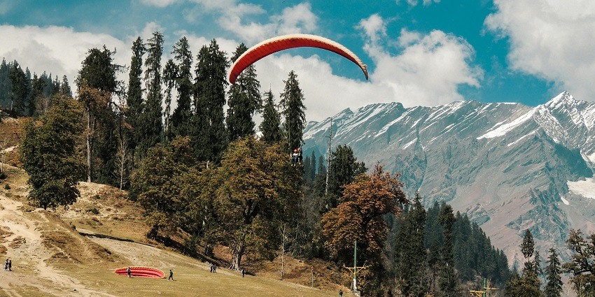 Enjoy the pleasant weather of Himachal Pradesh while paragliding in Shimla, India.