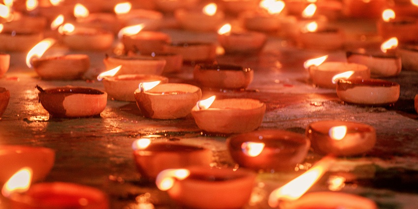 Image of festival of lights celebration, Clay diya candles in a temple