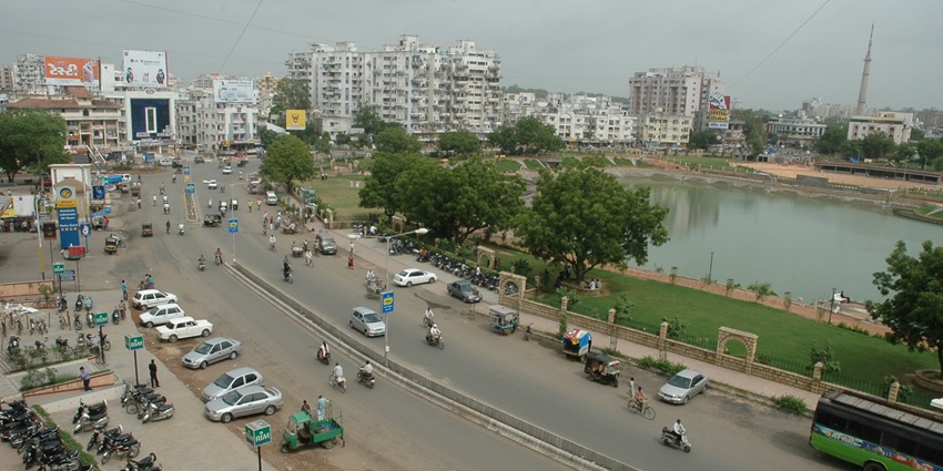 Aerial View of Vastrapur Lake near bustling traffic and tall building on side