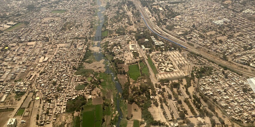 Bird’s-eye view of Aji River in Rajkot, showcasing the river winding through the landscape.