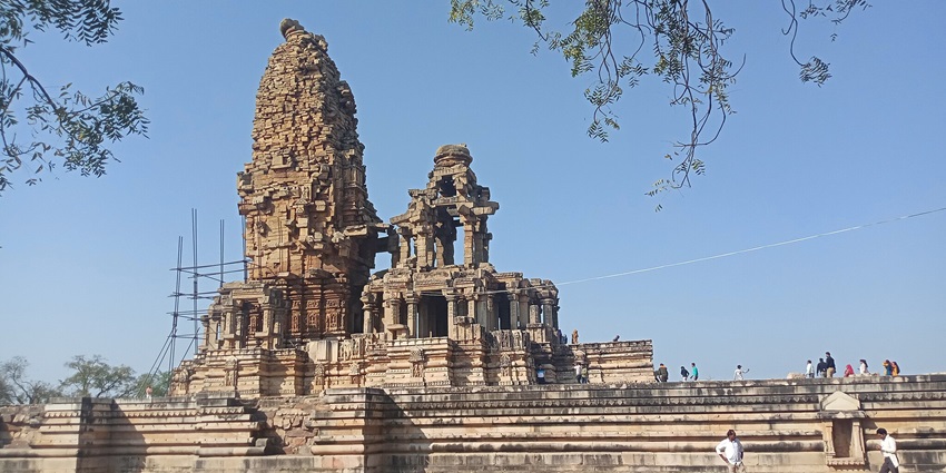 Ancient ruins and intricate architecture of the temple bustling with devotees.