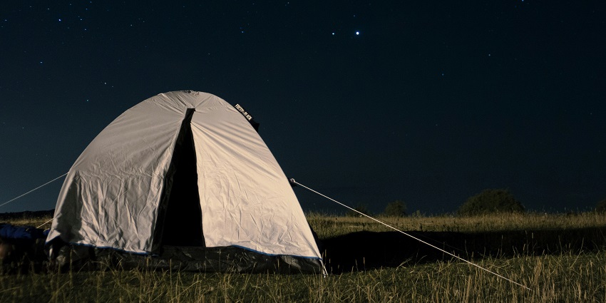 Image of camping under the star night time near the valley with lush green surroundings