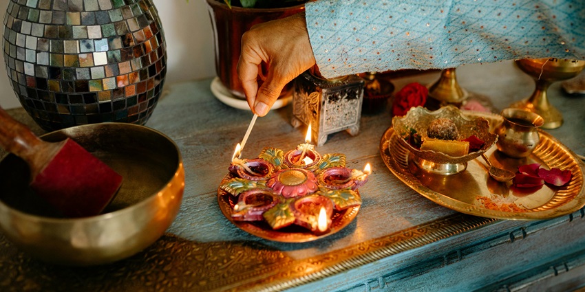 An image depicting illuminated and vibrant diyas arranged near the Ramdevra temple
