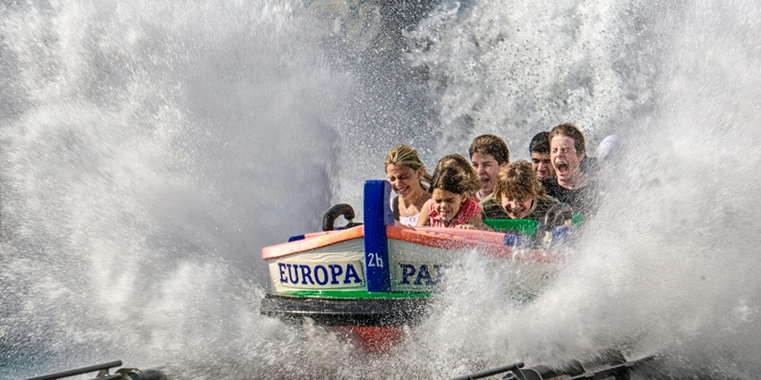 Children giggle as they glide down vivid water slides, portraying the joy of water parks