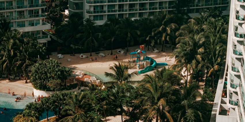 Breathtaking aerial view of a vibrant water park nestled among towering high-rise buildings