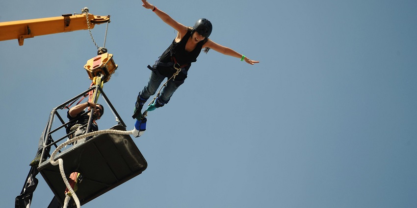 person mid-air during a bungee jump, showcasing the excitement of extreme sports.