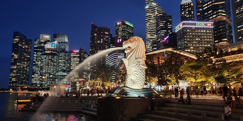 The Singapore skyline at dusk, featuring a view of iconic skyscrapers and landmarks.