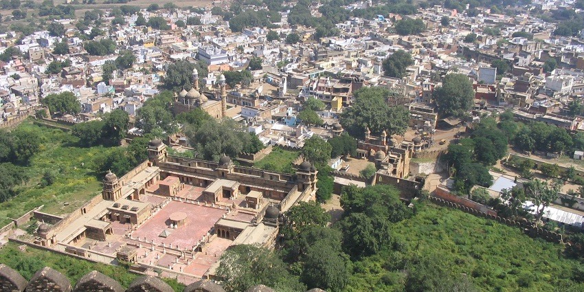 Panoramic view of Gwalior city, showcasing historical buildings and landscape from a high point.