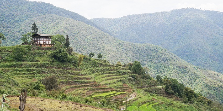 Bhutan's diverse landscapes featuring verdant valleys, rolling hills, and distant mountain ranges.