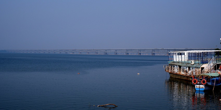 A breathtaking view of a sparkling water body with a port on the side during the day.