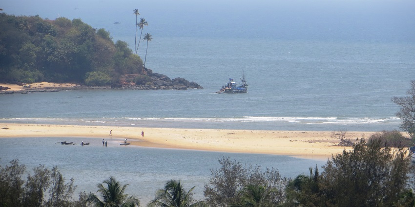 Panoramic aerial snap beach side where a river meets the ocean and forms a tiny island