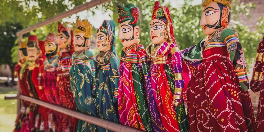 Male and female dolls dressed in vibrant, colourful traditional costumes on display at the Bhagat Ki Kothi Museum.