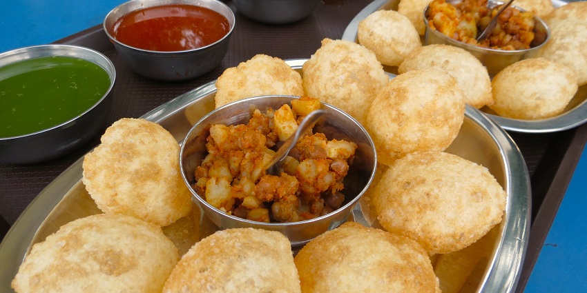Pani puri served on a plate with spicy water, showcasing a popular Indian street food that offers some of the best food in Bhuj.