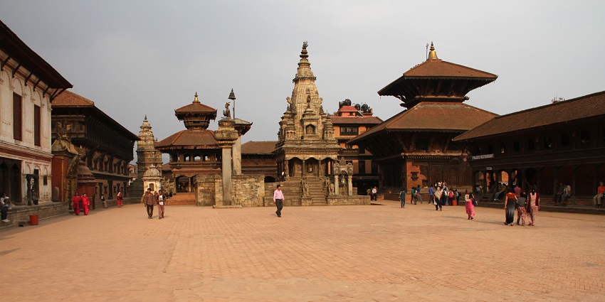 A picture of a traditionally built building in Nepal with many tourists visiting to explore its beauty