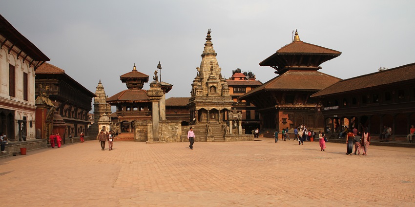 A picture of a traditionally built building in Nepal with many tourists visiting to explore its beauty