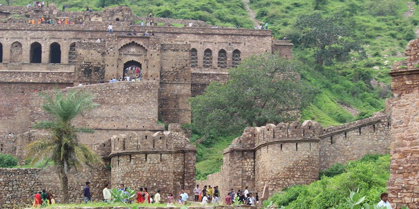 An image of Bhangarh Fort situated in Alwar with rocky ramparts and arched windows