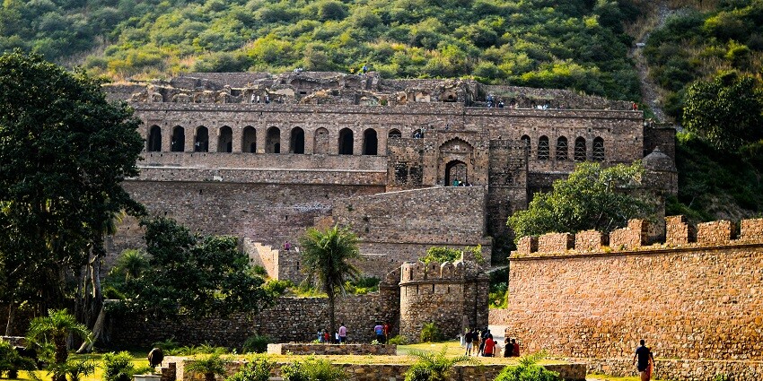 Bhangarh Fort, a haunted abode surrounded by lush green vegetation in Rajasthan.