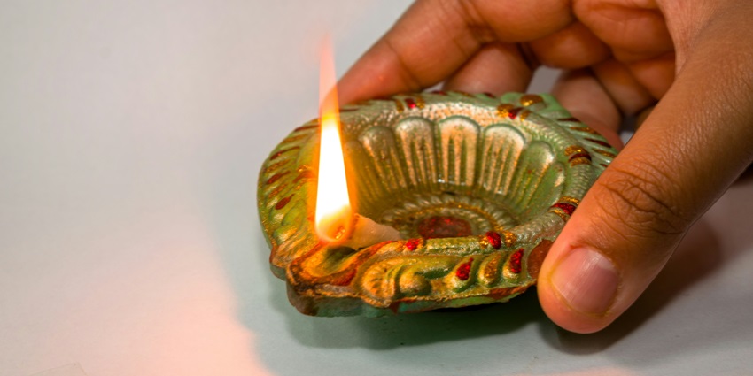 Lit candles for worship, symbolising devotion to Baba at Sariska's Bhartrihari Temple.