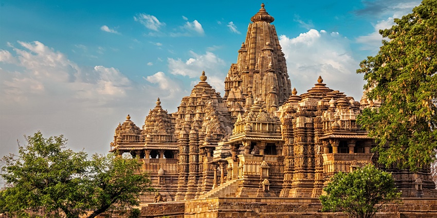 Ancient stone temple with ornate pillars and detailed carvings at the entrance.