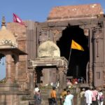 Vibrant entrance filled with bustling devotees and lively energy of pilgrims.