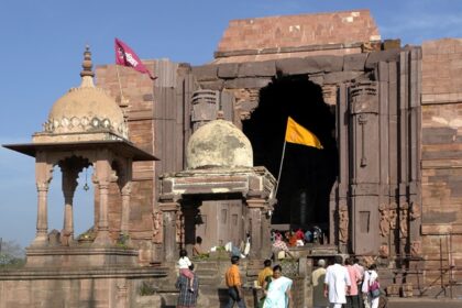 Vibrant entrance filled with bustling devotees and lively energy of pilgrims.