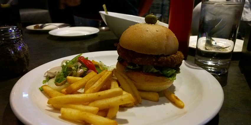 Veggie Burger with Bean Patty and French Fries on the table of a restaurant