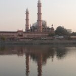 Taj-ul-Masajid , the biggest mosque in India, with its grand domes and minarets, reflected in the adjacent lake